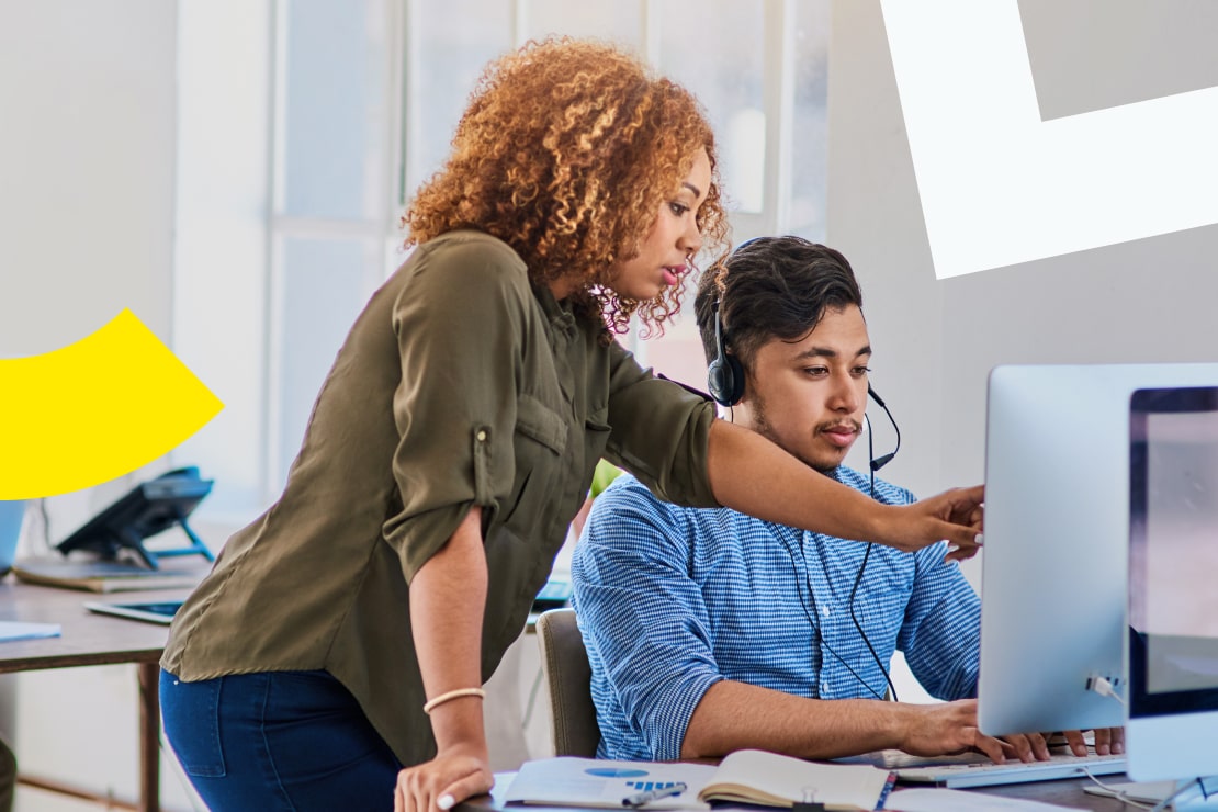 Manager coaching and training agent with AI quality management software, with staff wearing headsets and working at workstations.