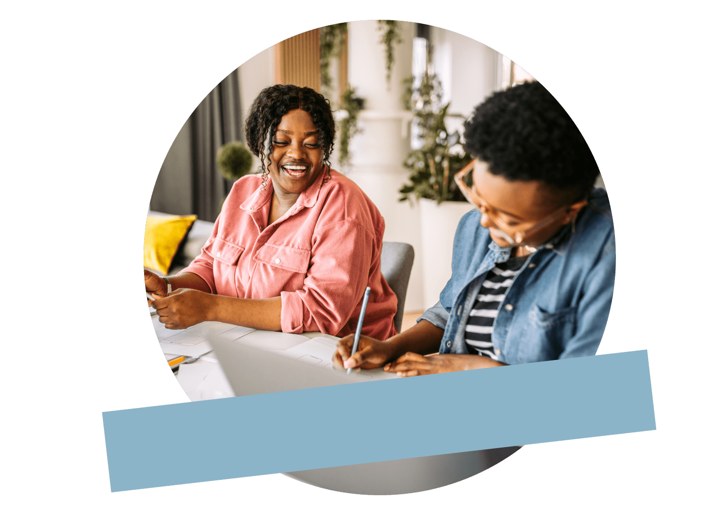 Two coworkers in a small business smiling while taking notes