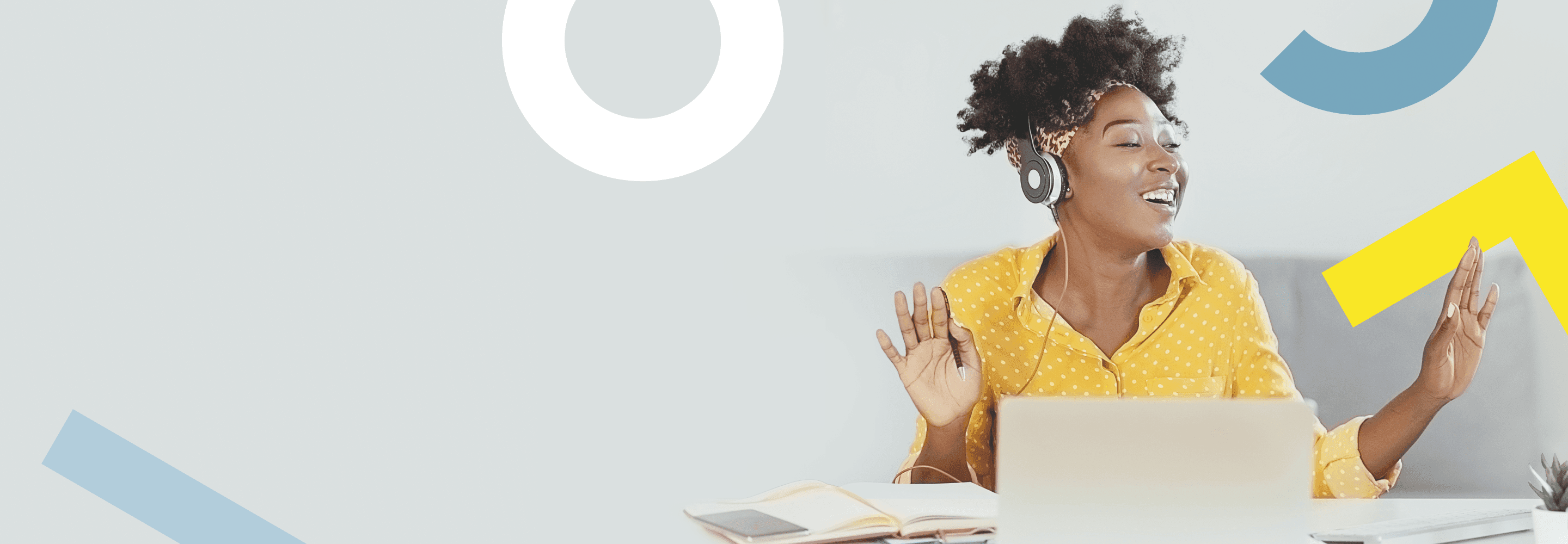 Individual sitting at desk celebrating award win.