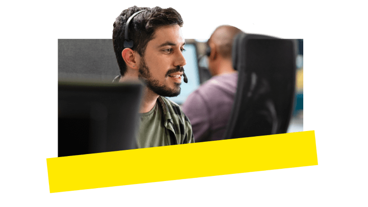 A support agent in an office space connecting to customers.